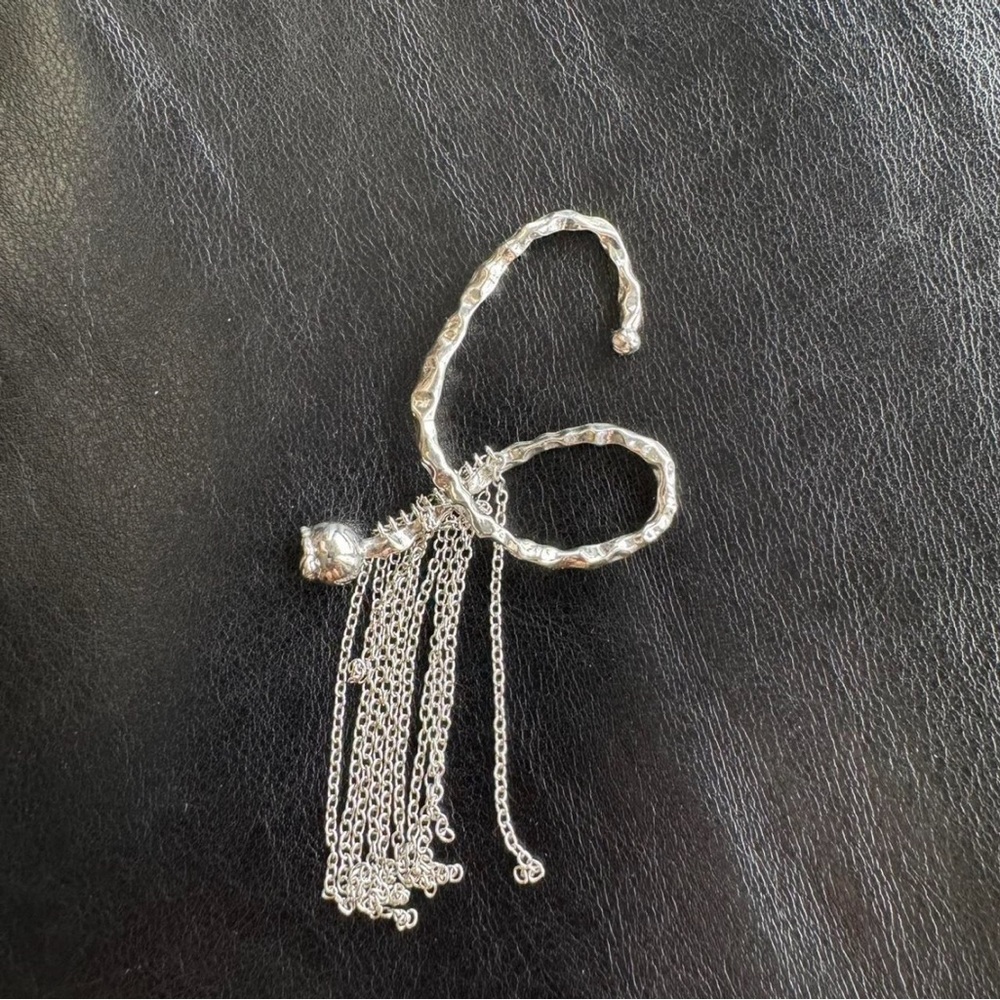 Silver tone avant garde abstract ear cuff with dangling chain tassels